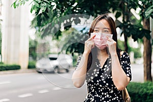 Asian woman wearing face mask to protect from Coronavirus (COVID-19) outbreak in city