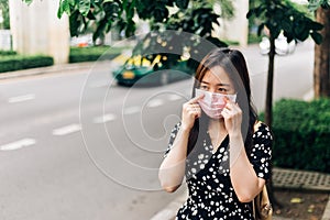 Asian woman wearing face mask to protect from Coronavirus (COVID-19) outbreak in city