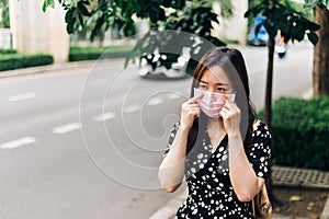 Asian woman wearing face mask to protect from Coronavirus (COVID-19) outbreak in city