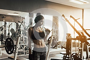 Asian woman wearing headphones for listening music at gym