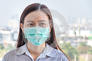 Asian woman wearing hygienic protect face mask to prevent COVID-19  coronavirus infection while outside home during covid virus