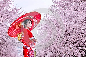 Asian woman wearing japanese traditional kimono and cherry blossom in spring, Japan