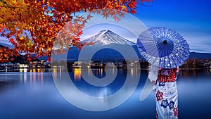 Asian woman wearing japanese traditional kimono at Fuji mountain in autumn, Kawaguchiko lake in Japan