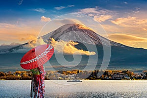 Asian woman wearing japanese traditional kimono at Fuji mountain. Sunset at Kawaguchiko lake in Japan