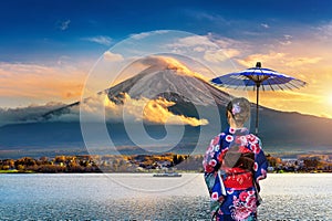 Asian woman wearing japanese traditional kimono at Fuji mountain. Sunset at Kawaguchiko lake in Japan