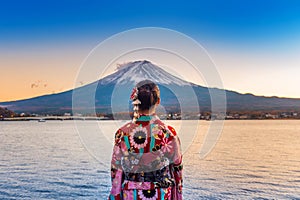 Asian woman wearing japanese traditional kimono at Fuji mountain. Sunset at Kawaguchiko lake in Japan