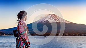 Asian woman wearing japanese traditional kimono at Fuji mountain. Sunset at Kawaguchiko lake in Japan