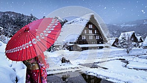 Asian woman wearing japanese traditional kimono at Shirakawa-go village in winter, UNESCO world heritage sites, Japan.