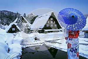 Asian woman wearing japanese traditional kimono at Shirakawa-go village in winter, UNESCO world heritage sites, Japan. photo