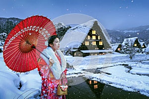 Asian woman wearing japanese traditional kimono at Shirakawa-go village in winter, UNESCO world heritage sites, Japan.