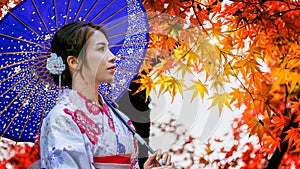 Asian woman wearing japanese traditional kimono with umbrella in autumn park. Japa