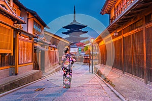 Asian woman wearing japanese traditional kimono at Yasaka Pagoda and Sannen Zaka Street and old house in Kyoto, Japan. photo