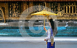 Asian woman wearing laos traditional at Wat Xieng Thong Golden City Temple in Luang Prabang, Laos