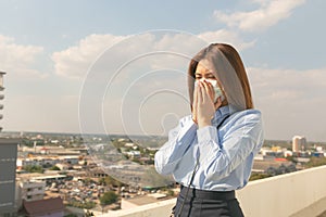 Asian woman wearing mask sick and pollution in the city PM2.5