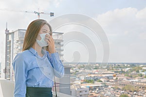 Asian woman wearing mask sick and pollution in the city PM2.5