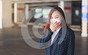 An asian woman wearing protective face mask for Healthcare and Covid-19 or 2020 virus concept