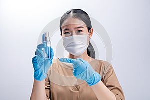 Asian woman wearing protective mask and presenting alcohol antiseptic gel