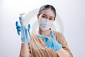 Asian woman wearing protective mask and presenting alcohol antiseptic gel