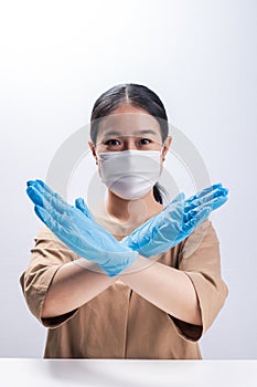 Asian woman is wearing sanitary gloves, mask on her face against coronavirus or COVID-19 disease. The Pollution Healthcare and