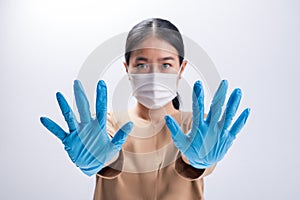 Asian woman is wearing sanitary gloves, mask on her face against coronavirus or COVID-19 disease. The Pollution Healthcare and