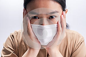 Asian woman is wearing sanitary gloves, mask on her face against coronavirus or COVID-19 disease. The Pollution Healthcare and