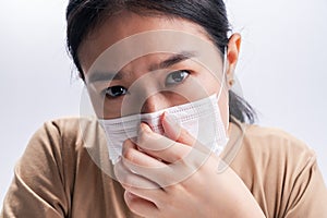 Asian woman is wearing sanitary gloves, mask on her face against coronavirus or COVID-19 disease. The Pollution Healthcare and