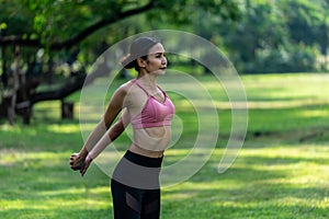 Asian woman wearing sportwear warming up body