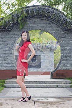Asian woman wearing traditional Cheongsam clothes portrait outdoor during Chinese New Year