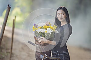 Asian woman wearing traditional thai culture,walking to go home on field