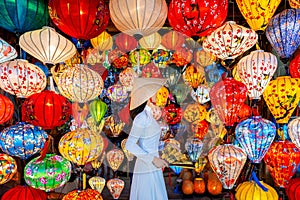 Asian woman wearing vietnam culture traditional and hoi an lanterns at Hoi An ancient town, Vietnam