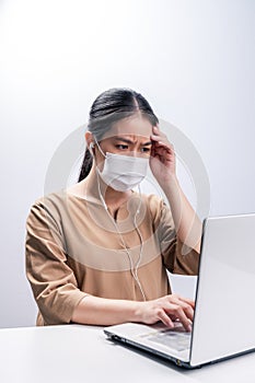 Asian woman wears protective mask and worry about Coronavirus on her working day on white background