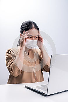 Asian woman wears protective mask and worry about Coronavirus on her working day on white background