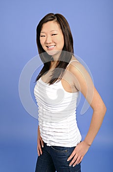 Asian woman in white tanktop and blue jeans