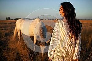 Asian Woman In White Walking Horse In Rural Field.