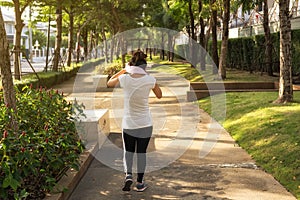 Asian woman wipe sweat after running