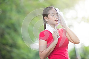 Asian woman wiping her sweat after exercise