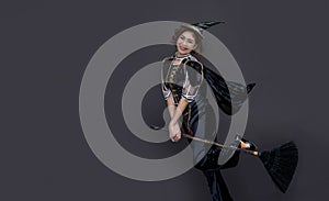 Asian woman with witch costume and old broom for halloween party concept on  background for advertising in hallowwen