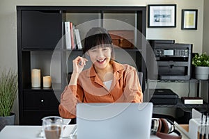 Asian woman work on computer laptop at home office. video call, studying, learning and working online