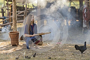 Asian woman worker winnowing rice separate.