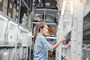 Asian woman worker working with digital tablet checking boxes Logistic import and export supplies packages in Warehouse ,