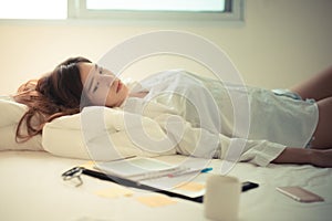 Asian woman working on the bed.