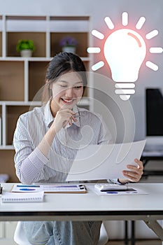 Asian woman working at home on desk using calculator to calculate tax accounting