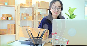 Asian woman working at home, young business start up with online business or sme concept.