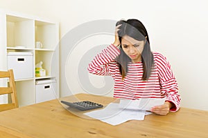 Asian woman worries about the expenditure photo