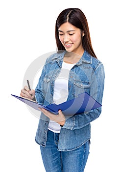 Asian woman write on clipboard