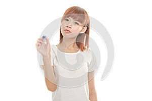 Asian woman writing with blue marker on imaginary board