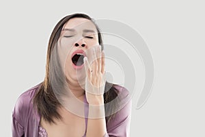 Asian woman yawning.