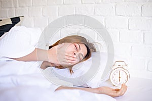 Asian woman yawning on bed and tired sleepy,Female having symptoms sleepiness photo