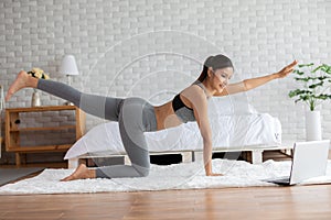 Asian woman yoga stretch online course at home