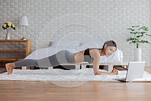 Asian woman yoga stretch online course at home